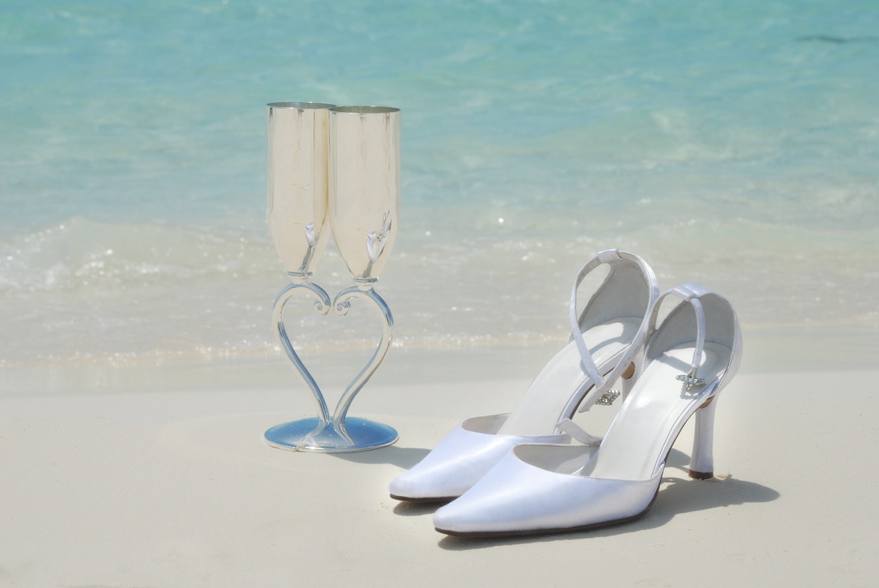 Wedding Shoes And Champagne Glasses On The Beach